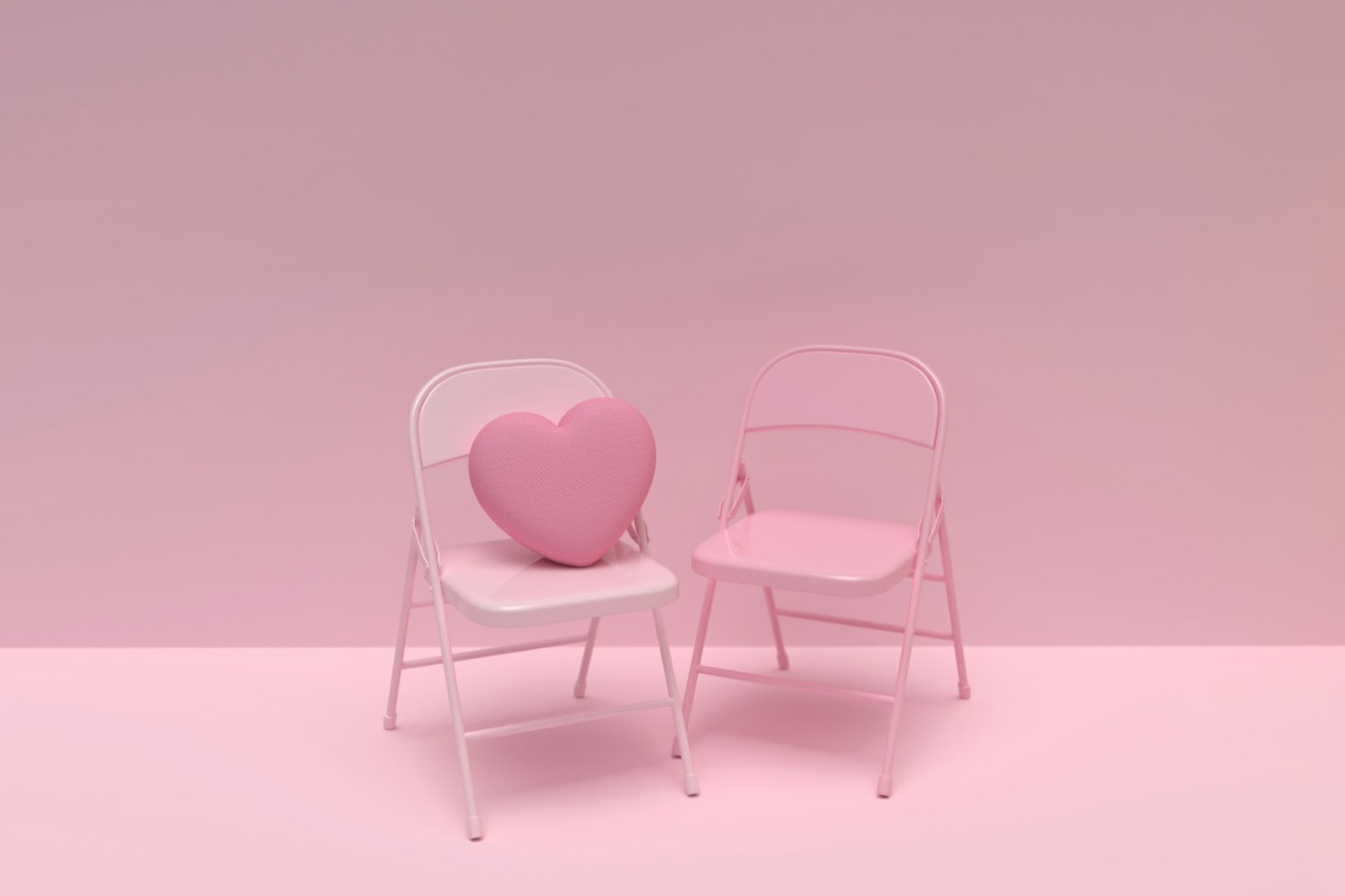 a pink chair and a white chair with a heart shaped pillow